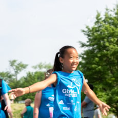 Girls on the Run participant smiling on 5K course